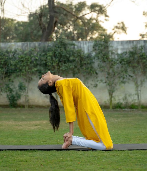 Woman in a calm, focused pose, representing mindful movement and breathing.